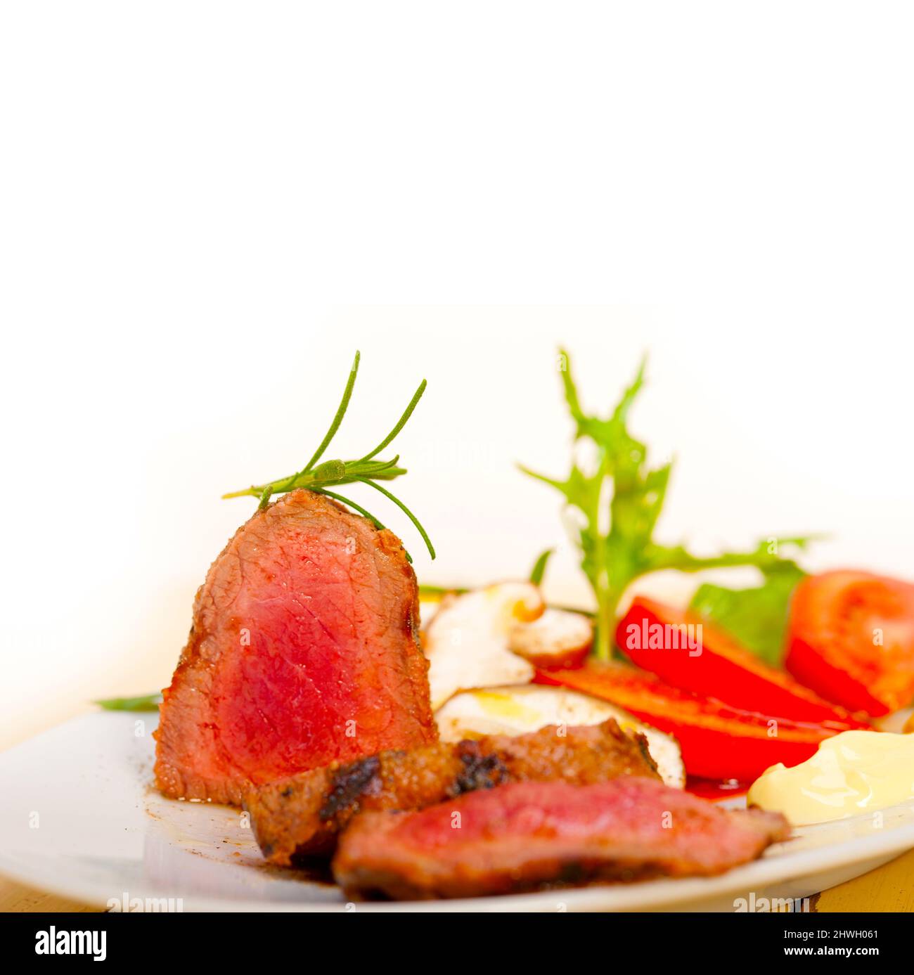 beef filet mignon grilled with fresh vegetables on side ,mushrooms