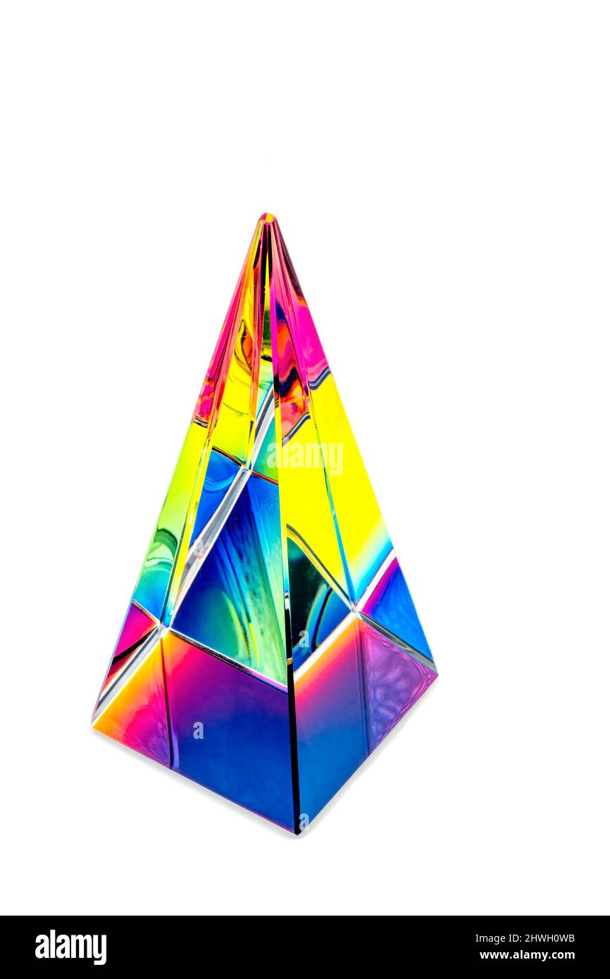Glass pyramid prism with colorful light reflection on background with