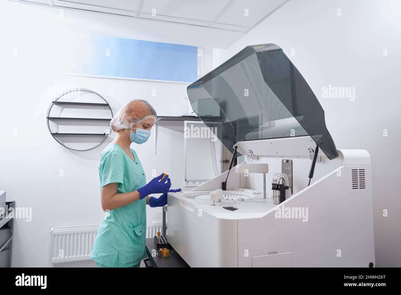 Doctor working biochemistry analyzer in hi-res stock photography and ...