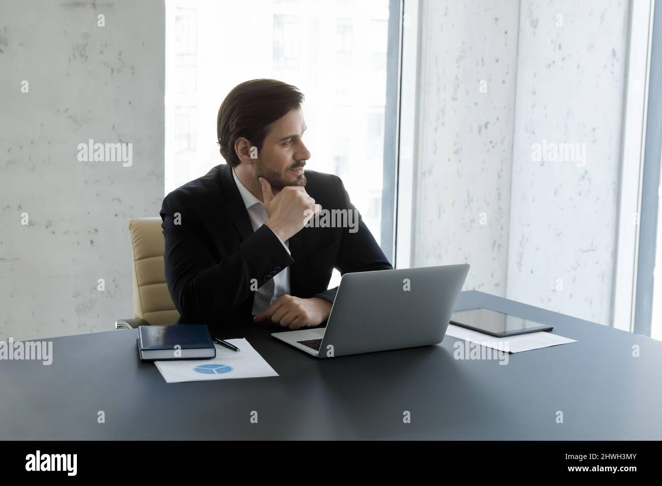 Distracted from computer work pensive man looking in distance. Stock Photo