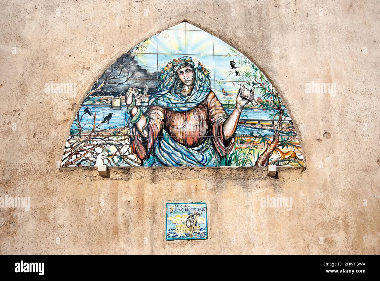 Painting on ceramic tiles (made in 1991 by the artist Gianni Capitani) on the wall of the historic center of Orbetello, Tuscany, Italy Stock Photo