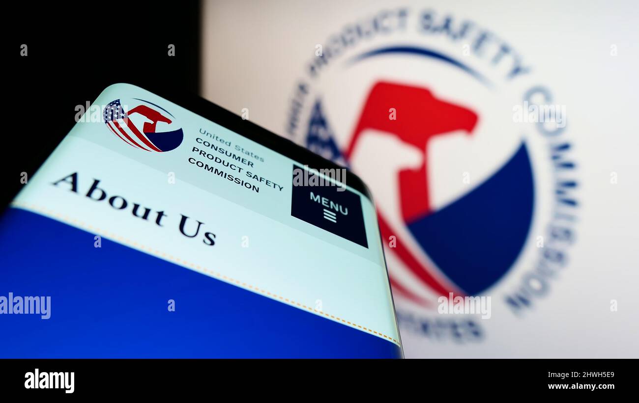 Mobile phone with webpage of United States Consumer Product Safety Commission (CPSC) on screen with logo. Focus on top-left of phone display. Stock Photo