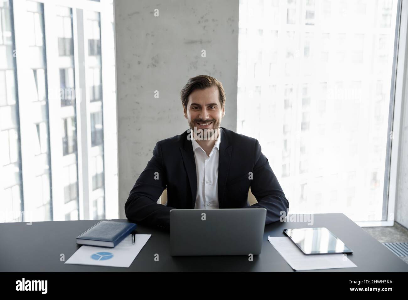 Smiling 30s young businessman looking at camera. Stock Photo
