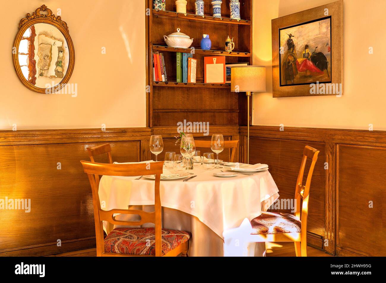 Interior view of an empty restaurant with a table in a corner, set in a warm and friendly atmosphere. Stock Photo