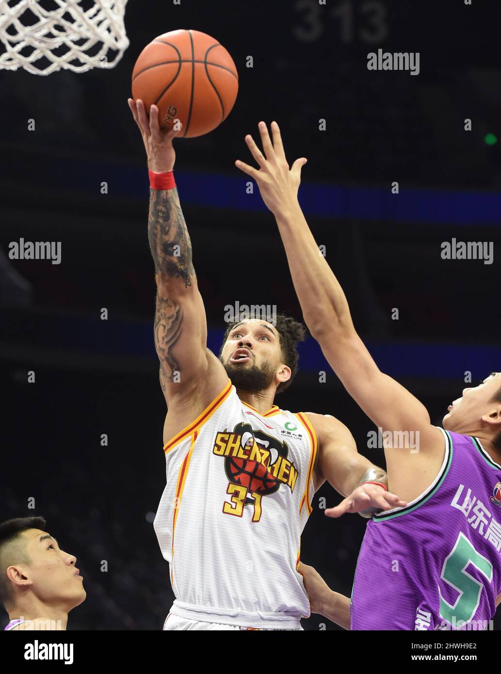 Foshan. 6th Mar, 2022. Askia Booker (C) of Shenzhen shoots during the