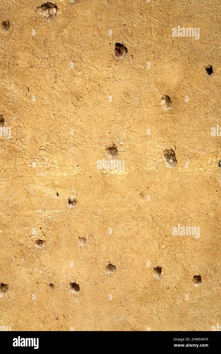 Bullet holes in a wall made during hostilities Stock Photo