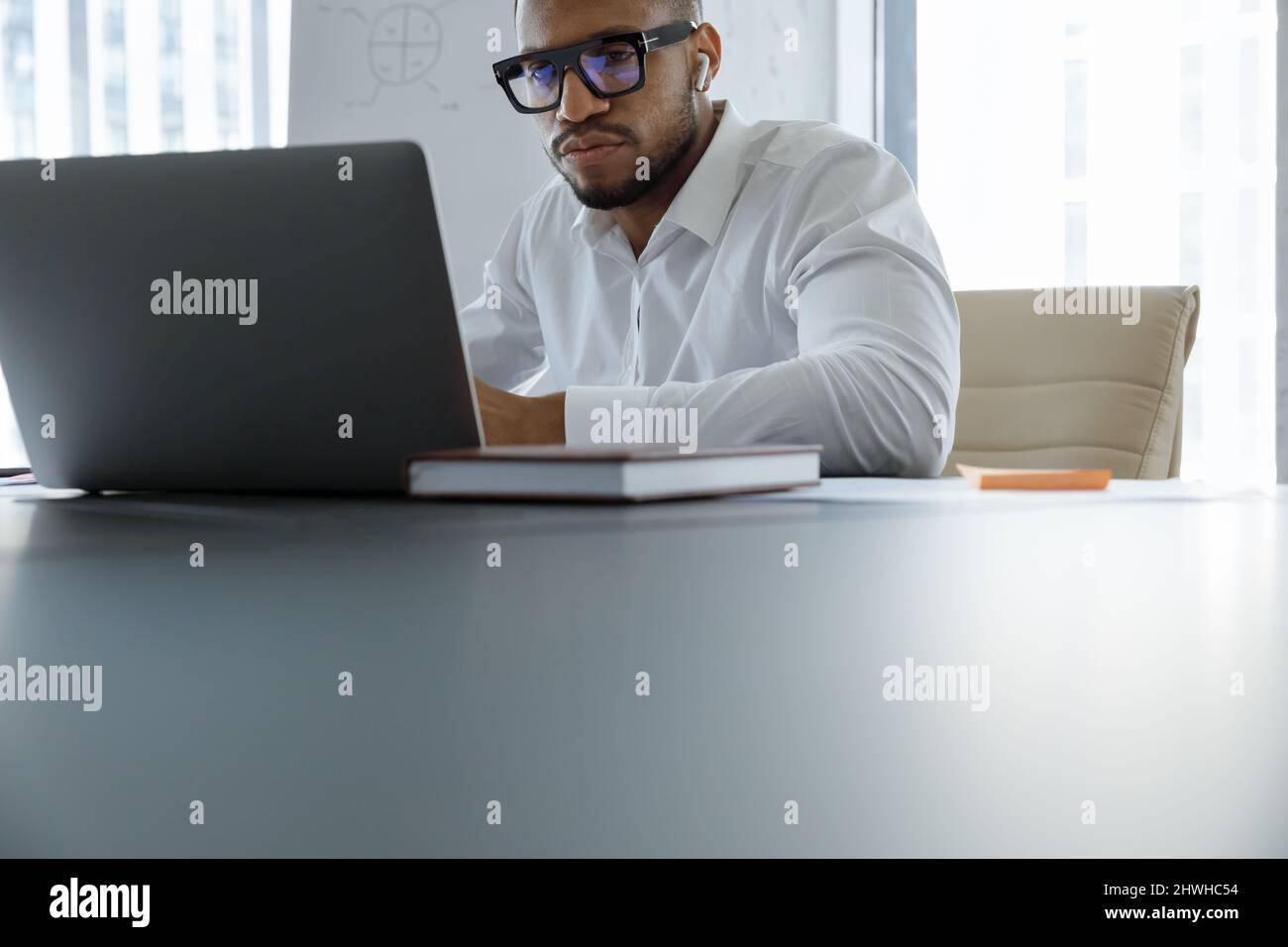 Thoughtful young African American working on computer. Stock Photo