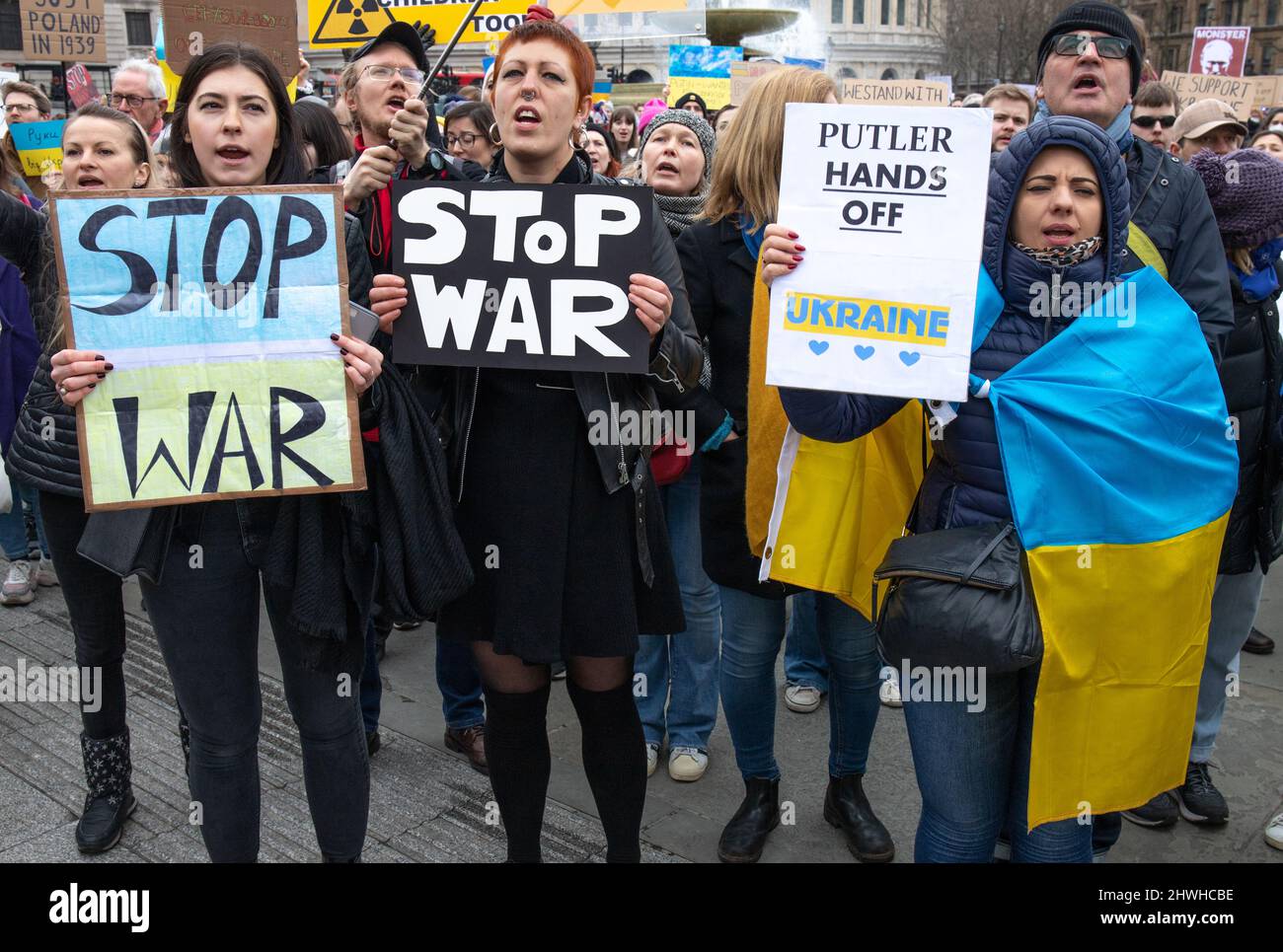 London, England, UK 5 March 2022 Around a thousand protesters gather in Trafalgar Square in solidarity with Ukraine and against Russia’s invasion of the country. Women and children hold banners, posters and placards with messages to Putin and Russia Credit: Denise Laura Baker/Alamy Live News Stock Photo