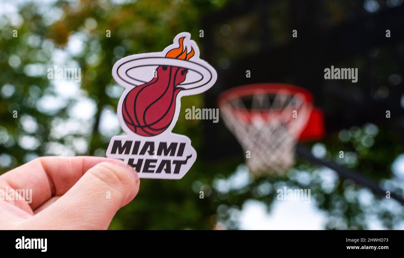 September 15, 2021, Miami, USA, A man holds the emblem of the Miami Heat basketball club in his hand on the sports ground. Stock Photo