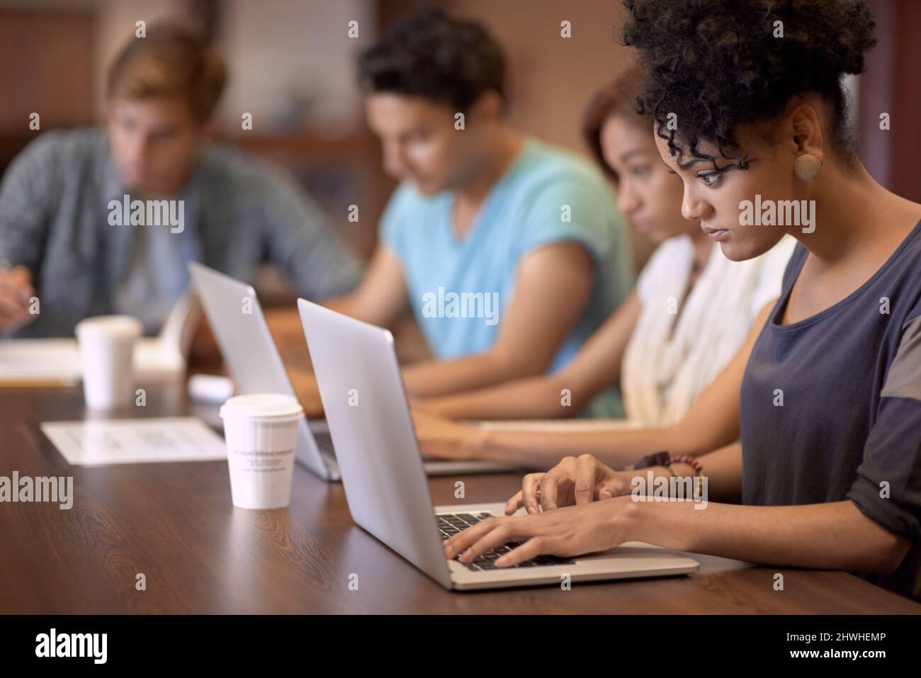 Theyve got a great study group. A group of students studying in the library. Stock Photo