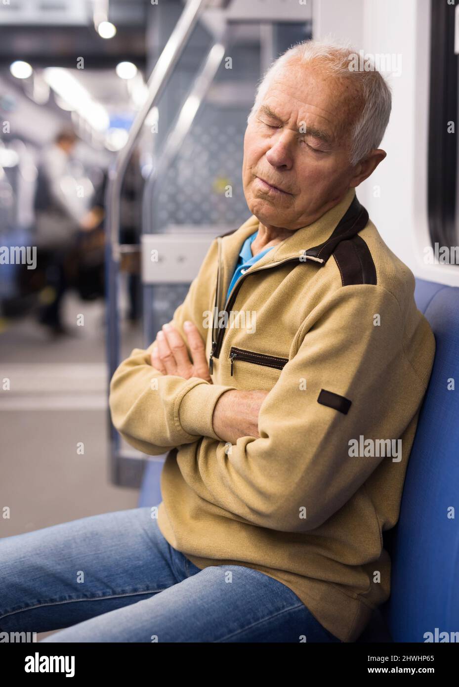 Old man sleeping in subway car Stock Photo