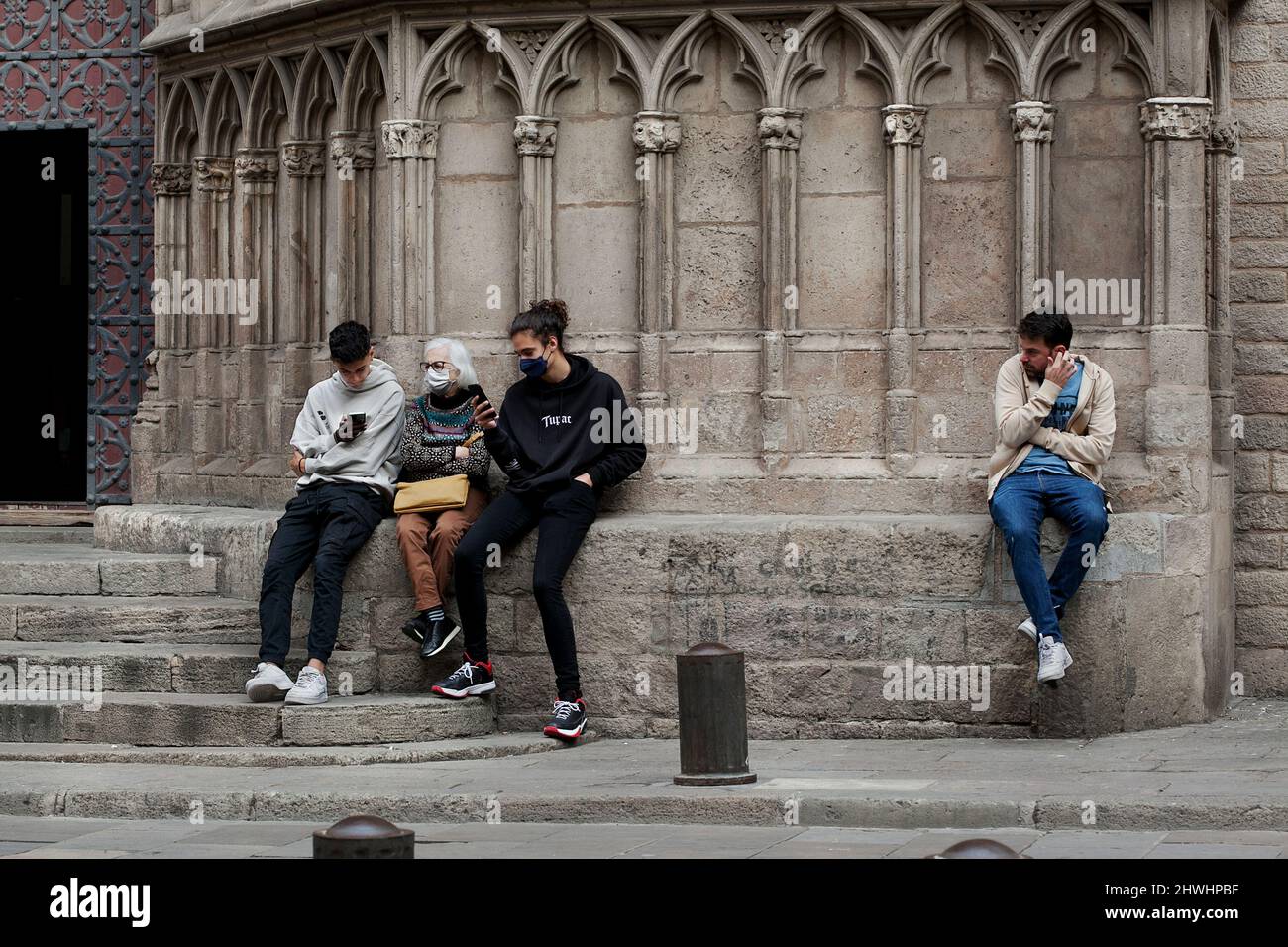 People sat outside The Santa Maria del Pi Basilica, Barcelona, Spain. Stock Photo