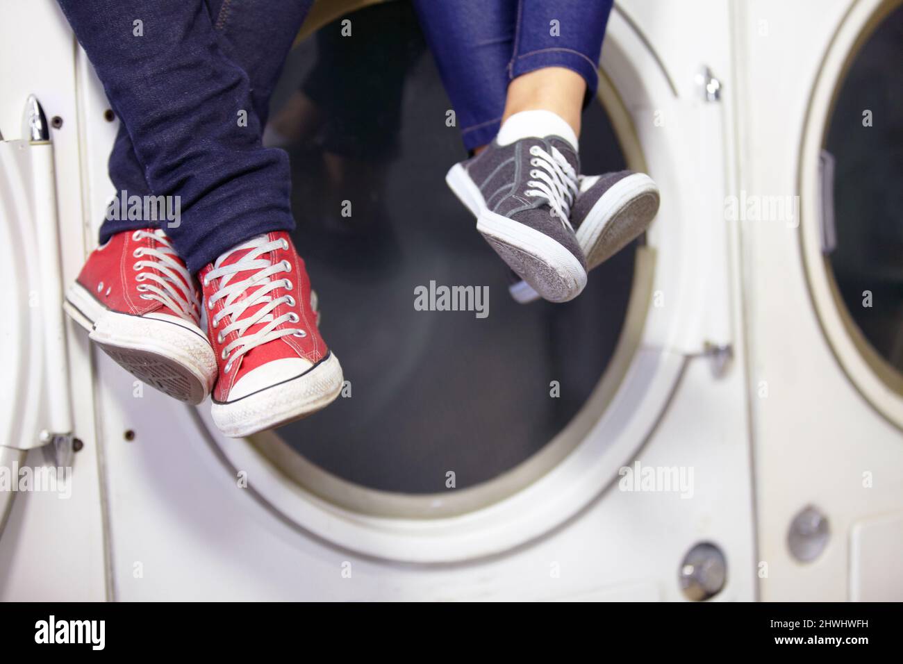 Theyre relaxed while doing laundry. Cropped image of a couples feet as