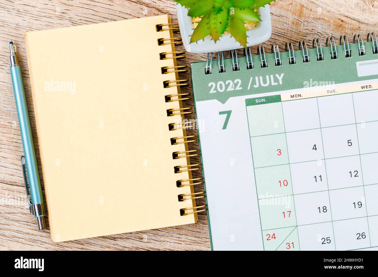 July 2022 desk calendar and diary with small plant on wooden background  stock photo - alamy