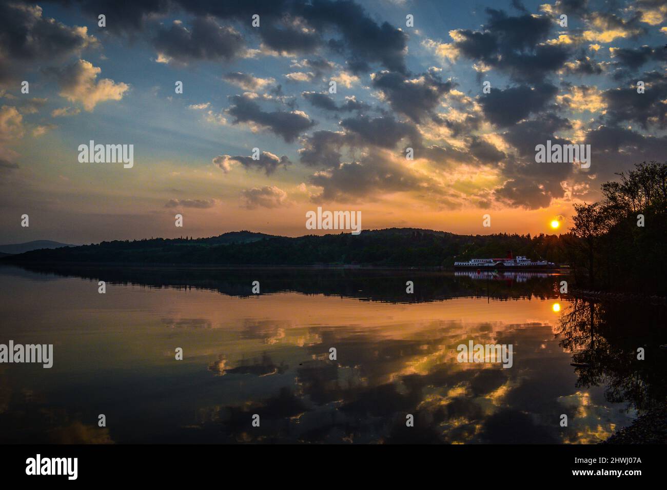 Scotland Sunrise Lake with clouds reflection Stock Photo