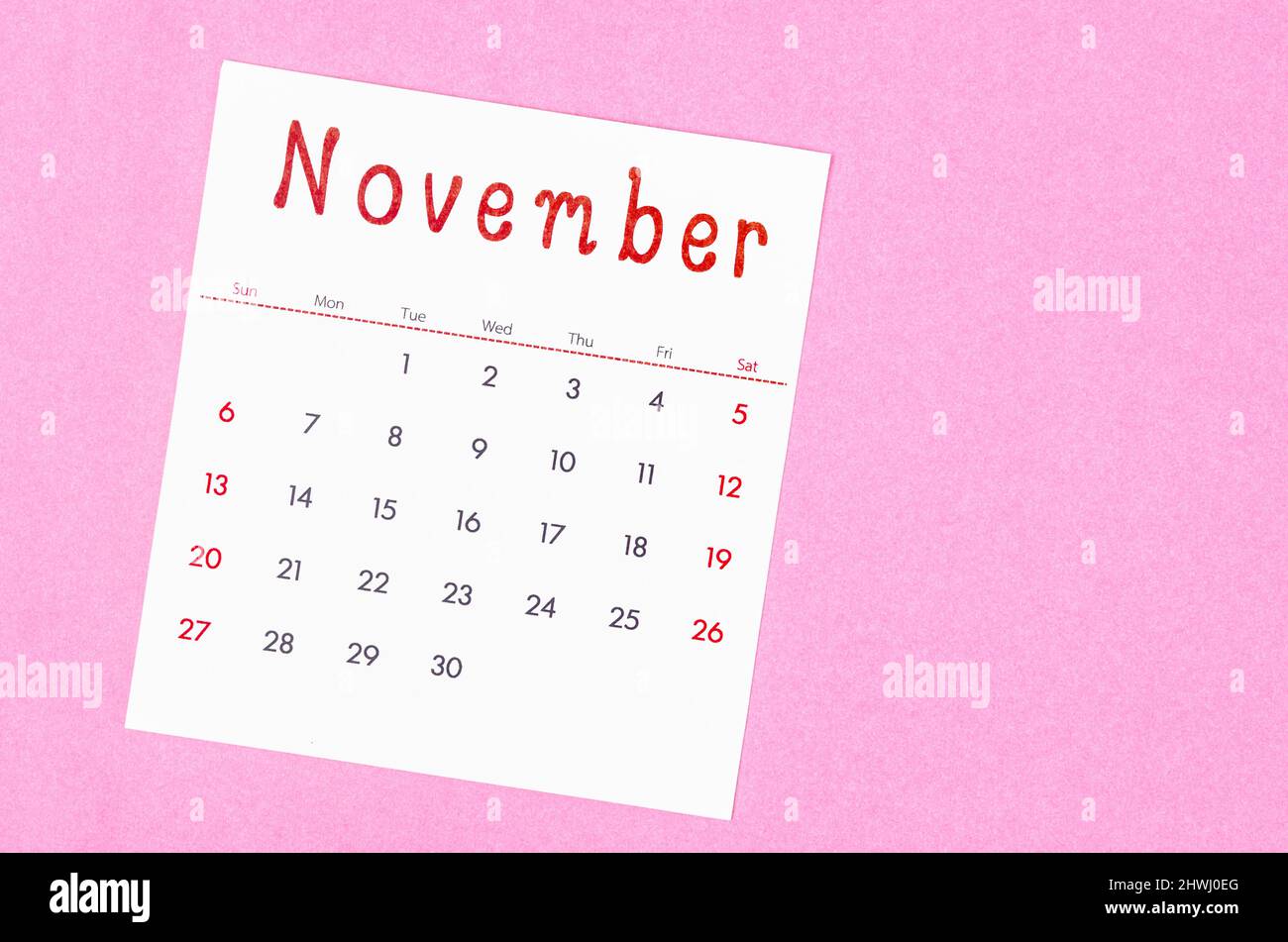 The November 2022 calendar on pink background with empty space. Stock Photo