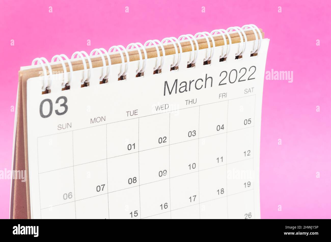 The March 2022 desk calendar on pink background with empty space. Stock Photo