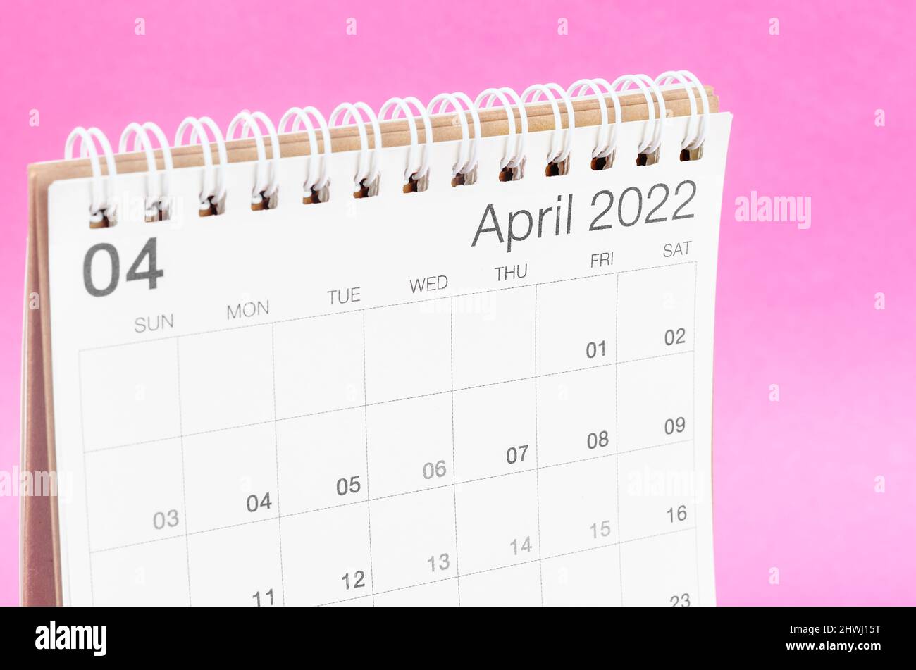 The April 2022 desk calendar on pink background with empty space. Stock Photo