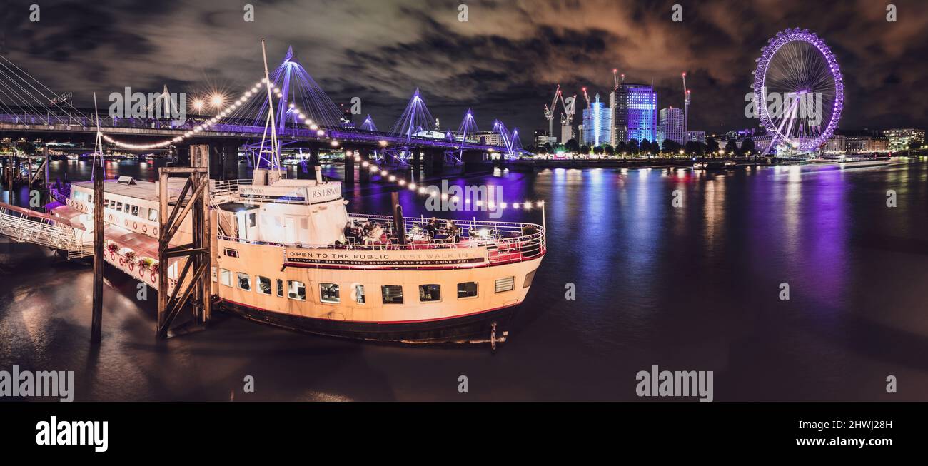 Panoramic London Boat with London eye by Night thames river reflection Stock Photo