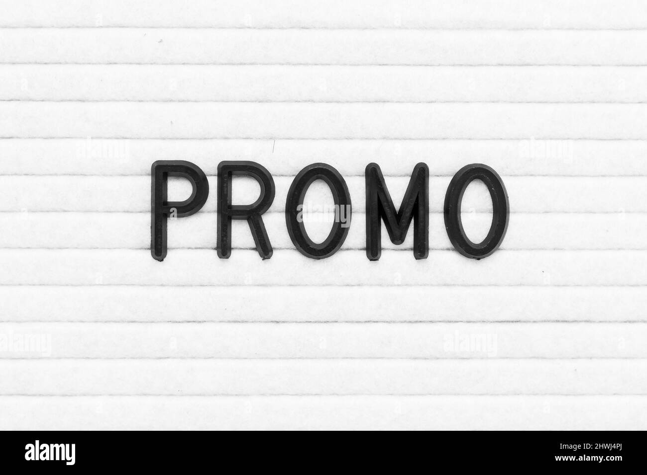 Black color letter in word promo on white felt board background Stock ...