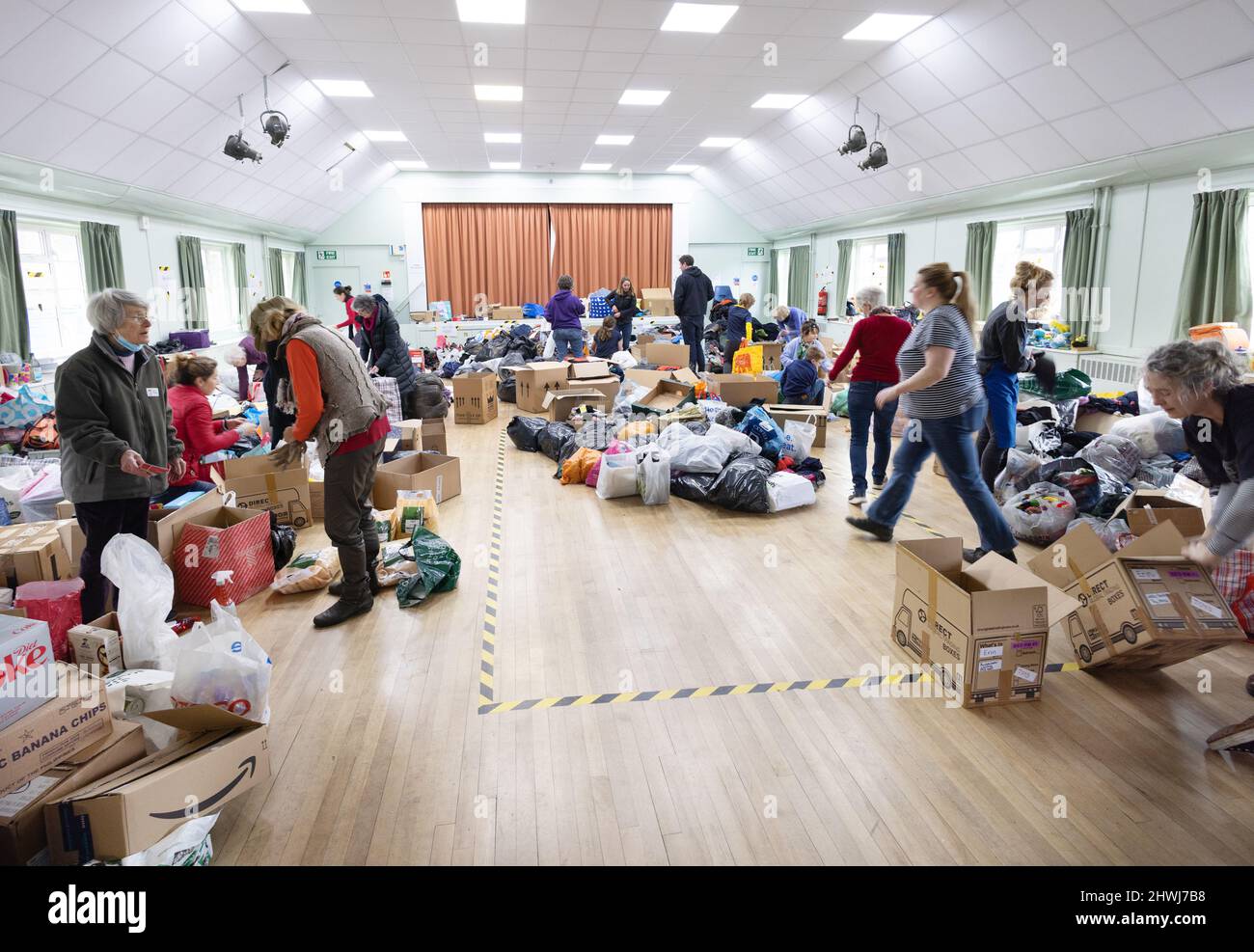 Ukraine aid; Volunteers sorting charitable donations for Ukrainian refugees from the Ukraine Russia war , 2022, Great Shelford Cambridgeshire UK Stock Photo
