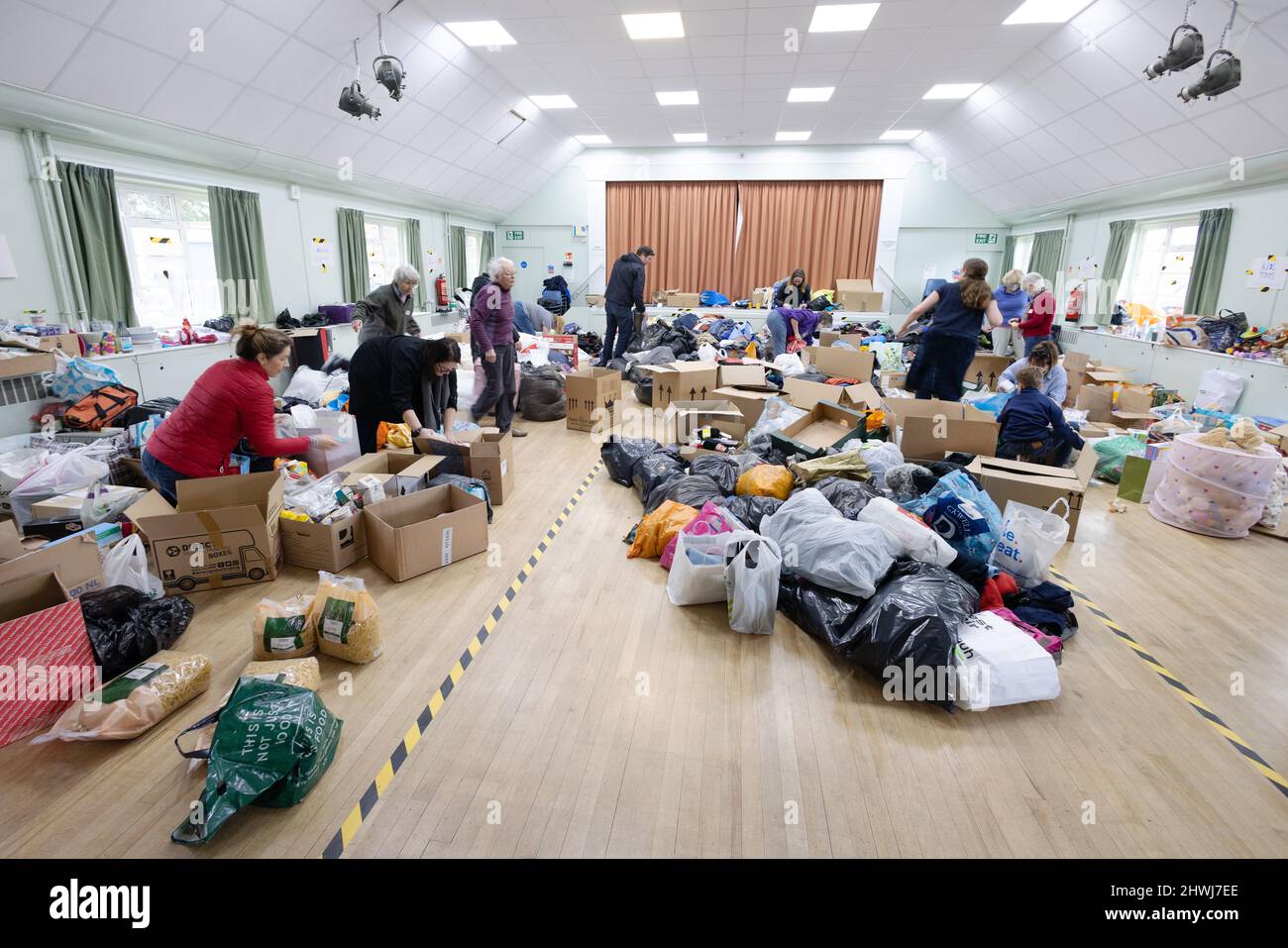 Ukraine Aid - war charity; Volunteers sorting charitable aid donations for Ukraine refugees, the Ukraine Russia war 2022, Great Shelford Cambridge UK Stock Photo