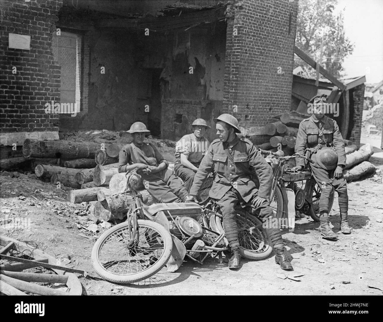 Two despatch riders seen with their motorcycles relaxing in a farmyard at Feuchy, 5 June 1917. Stock Photo