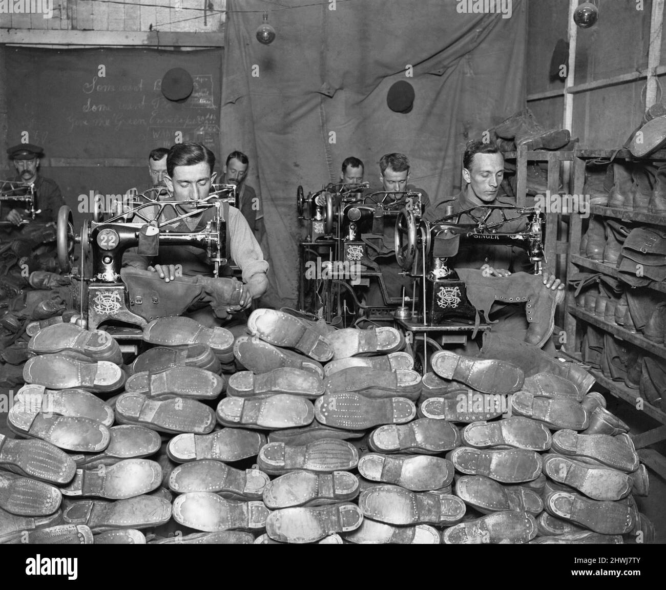 The British Army on the Western Front 1914-1918 Sorting boots to be repaired at an Army Boot Repair Shop at Calais. They dealth with 30,000 pairs per week. Stock Photo