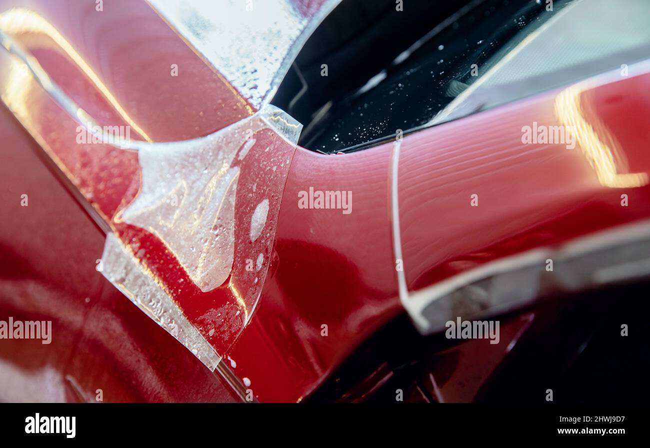 Master man installs vinyl film in risk zone of windshield to protect