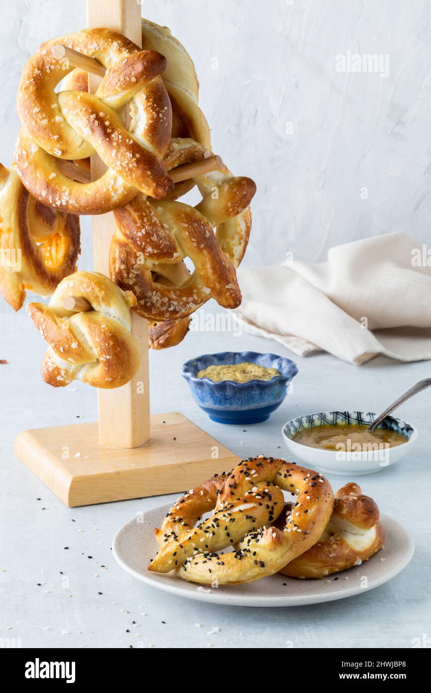 Homemade baked pretzels served with mustard dip and a tower of them in