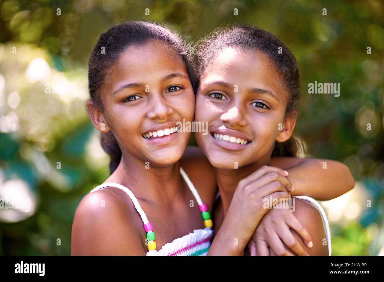 They have that twin connection. Portrait of two twin sisters standing