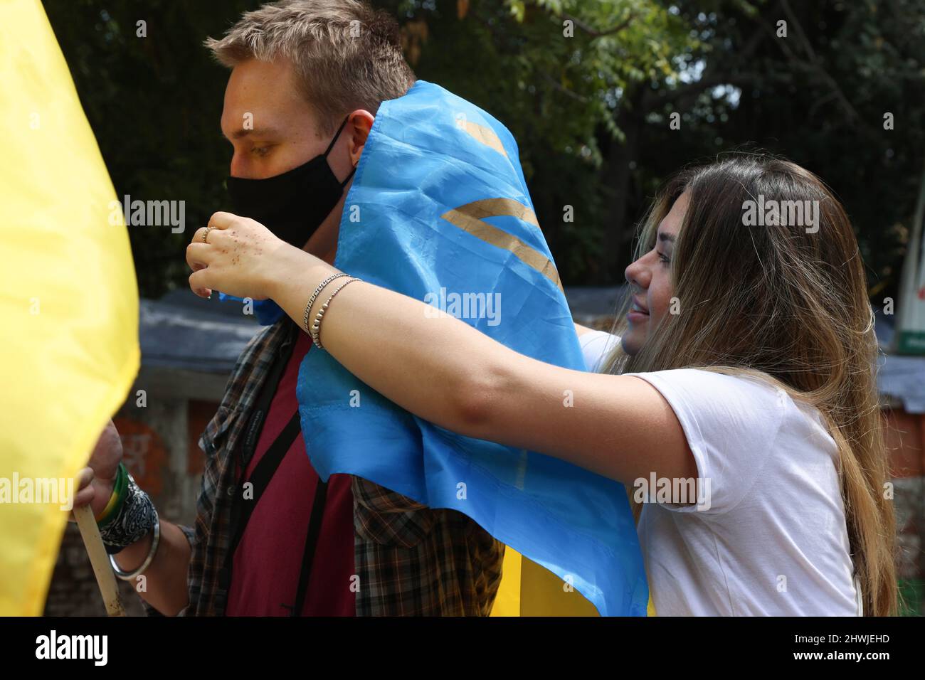 New Delhi, New Delhi, India. 6th Mar, 2022. A Ukrainian woman wraps a man with a national flag in solidarity with the people of Ukraine after Russia's invasion. (Credit Image: © Karma Sonam Bhutia/ZUMA Press Wire) Stock Photo