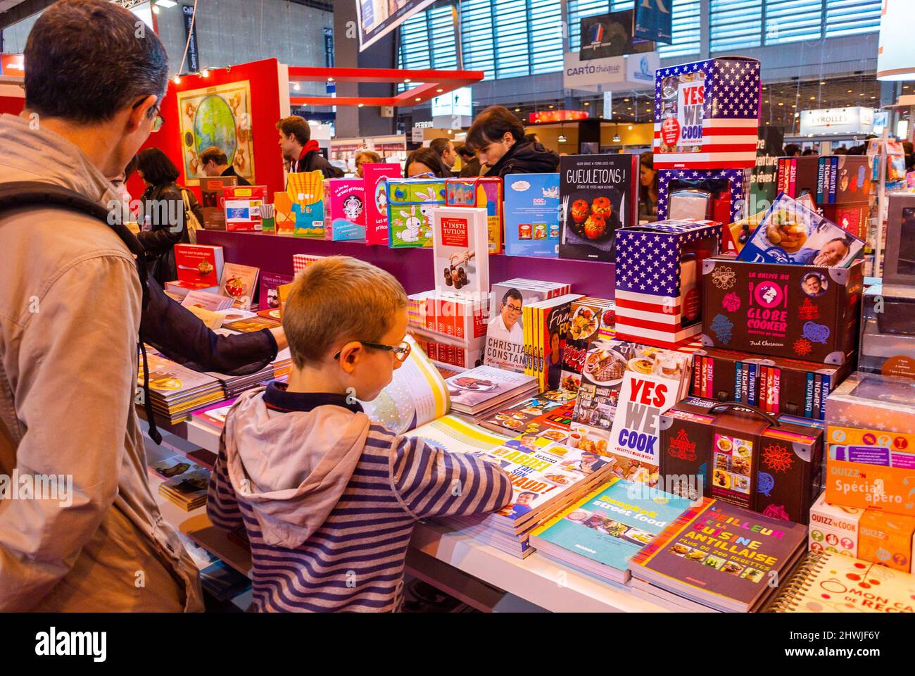 Paris, France, French Family, Child Reading Book from behind, at Salon de Livre, Trade Show, Book Store, Foire Exposition, fair, paris congress center display Stock Photo