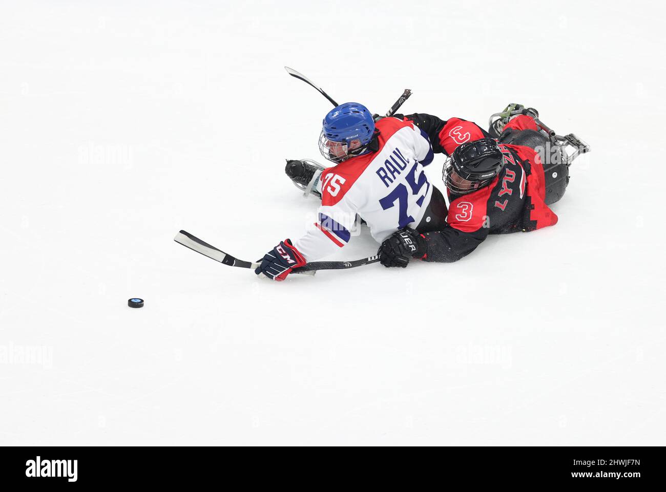 Beijing, China. 6th Mar, 2022. Lyu Zhi of China (R) vies with Jiri Raul of Czech Republic during the para ice hockey preliminary round Group B match between China and Czech Republic of the Beijing 2022 Paralympic Winter Games at National Indoor Stadium in Beijing, March 6, 2022. Credit: Hu Xingyu/Xinhua/Alamy Live News Stock Photo