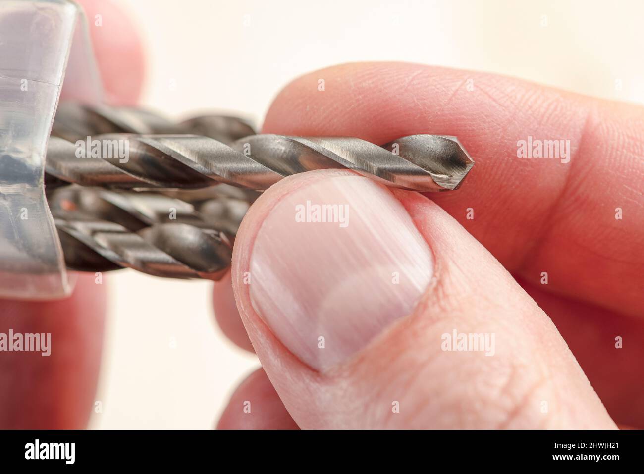 Installing a drill bit in a drill, hands take a drill and install it in