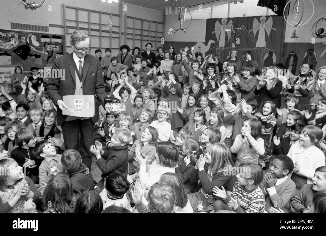 The children of St. Paul's Junior School in Upper Holly Walk, Leamington Spa, give a cheery send-off to their headmaster, Mr. T. T. Rutherford, who is leaving the school after 23 years' service.19th December 1973 Stock Photo