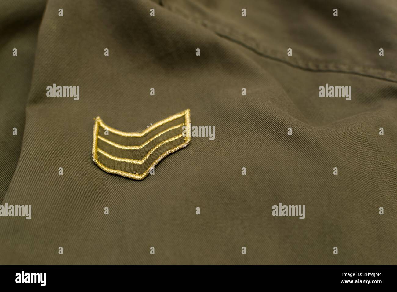 Military rank on military olive green uniform, close up Stock Photo