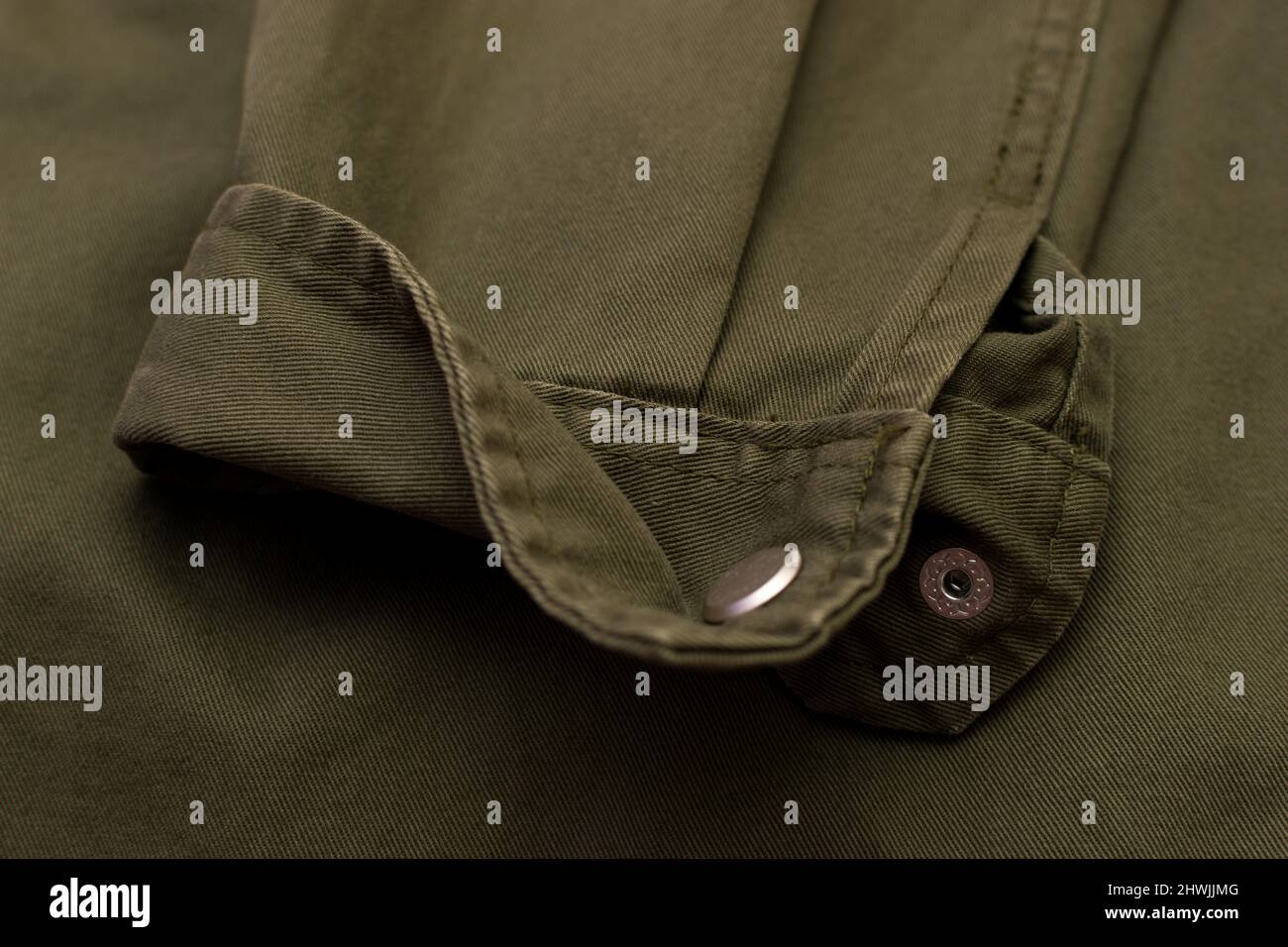 Close up of olive green vintage military uniform sleeve Stock Photo