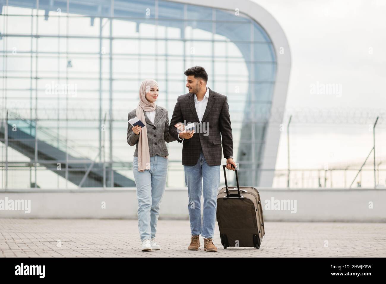 Portrait of happy muslim couple, woman in hijab and manin jacket ...
