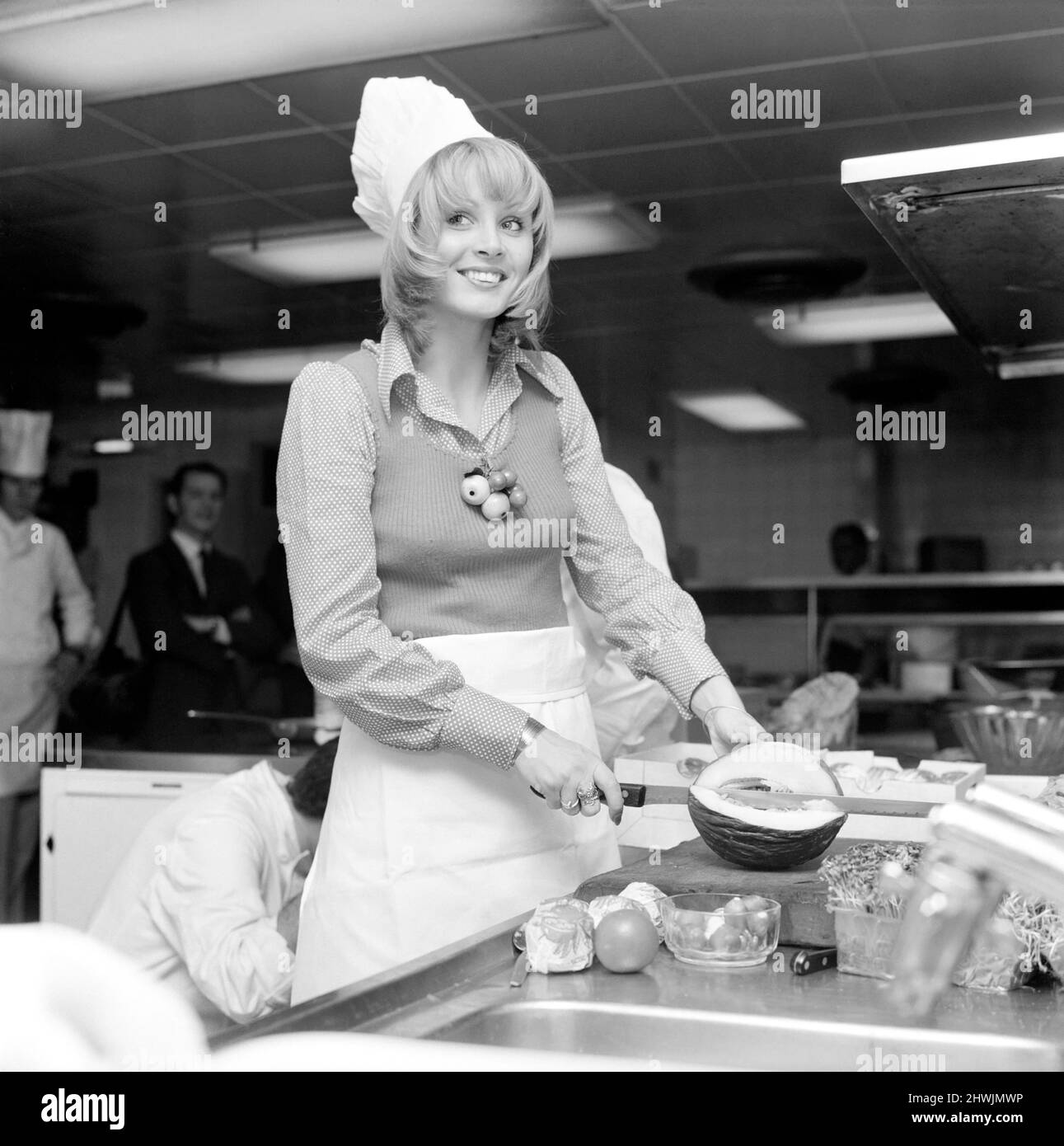 Miss World, 1972: Belinda Green: 20 year old Belinda Green, a blonde haired, blue eyed, model from Australia, won the Miss World Contest. Belinda's favourite hobby is cooking. Belinda in the kitchens of the Britannia Hotel, where she is staying, making herself something to eat this morning. December 1972 72-11299-001 Stock Photo