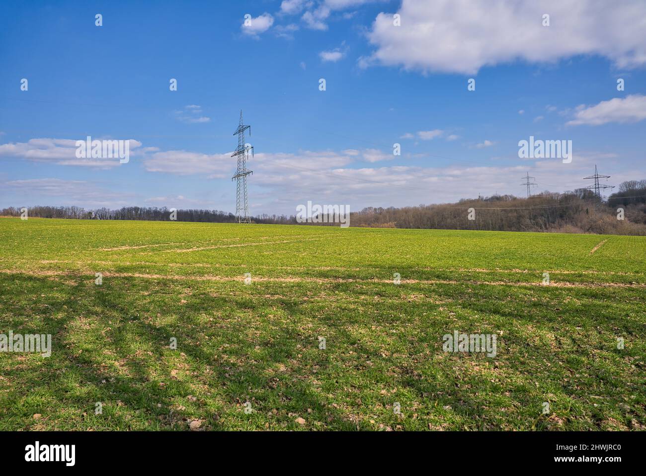 A High voltage pole with blue white sky Stock Photo - Alamy