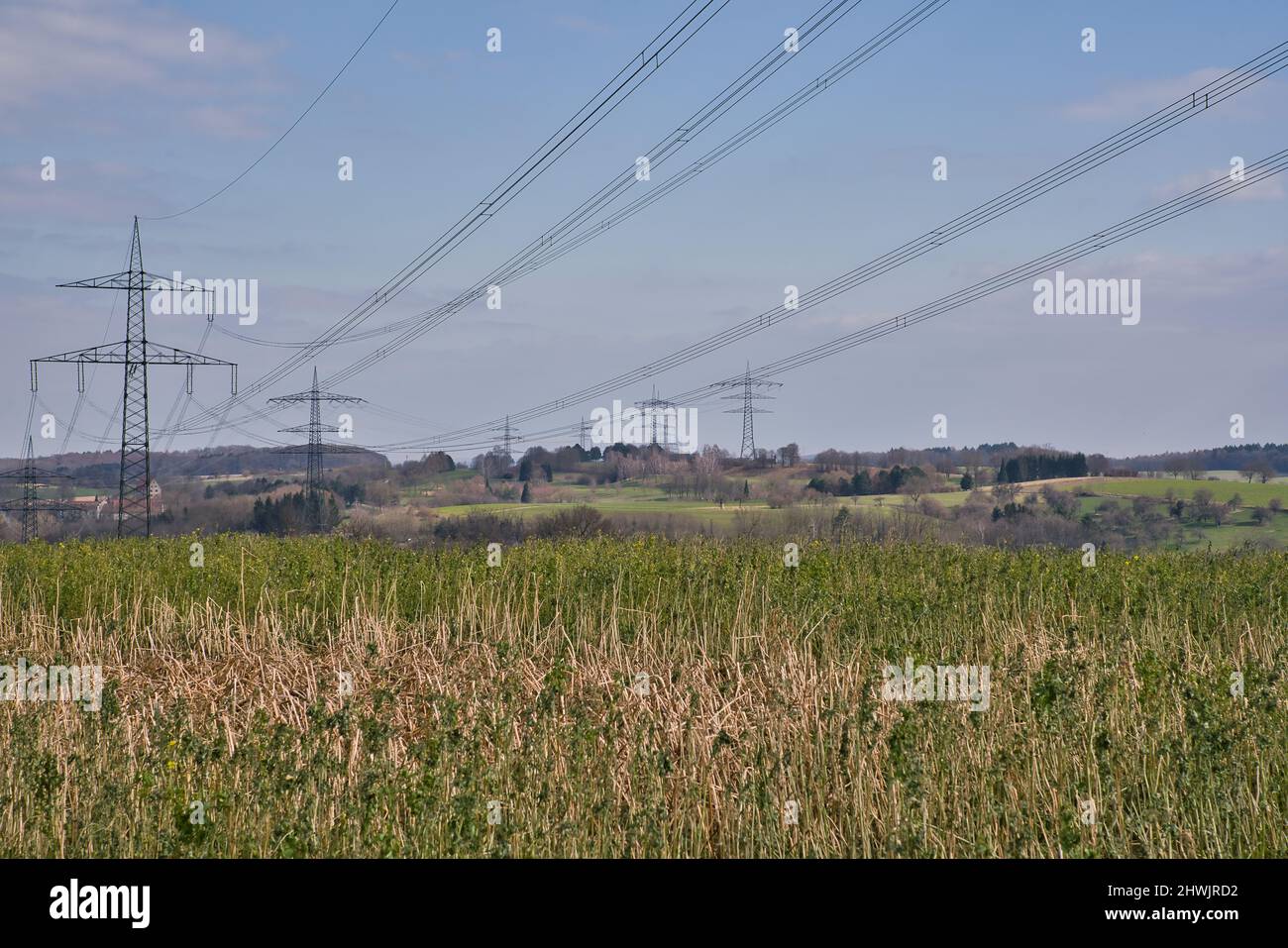 A High voltage pole with blue white sky Stock Photo - Alamy