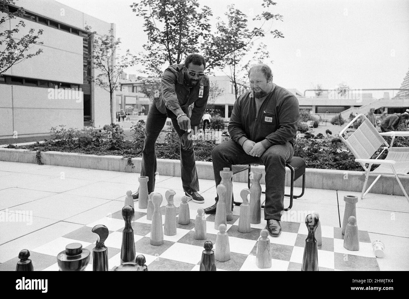 Olympic Games 1972 Munich Germany, Wednesday 23rd August 1972. Our picture shows ... John Carlos American sprinter watching a game of giant chess with welsh super heavy weightlifter Terry Perdue.  John Carlos caused controversy at the 1968 Mexico Games by giving a black power salute from the podium after receiving his bronze medal for the 200 metres. Stock Photo