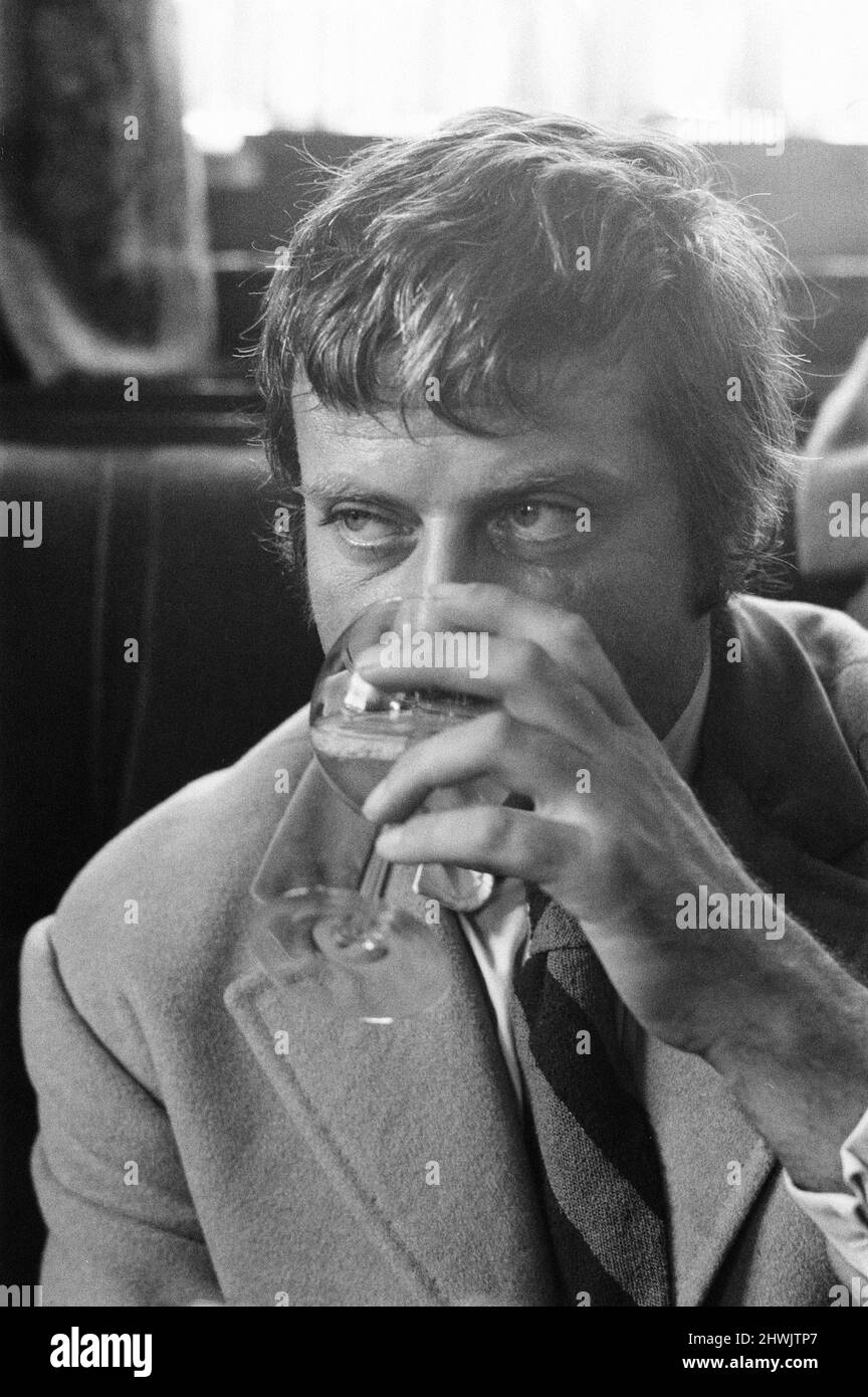 Oliver Reed, British actor, enjoys a few drinks at his local pub, The