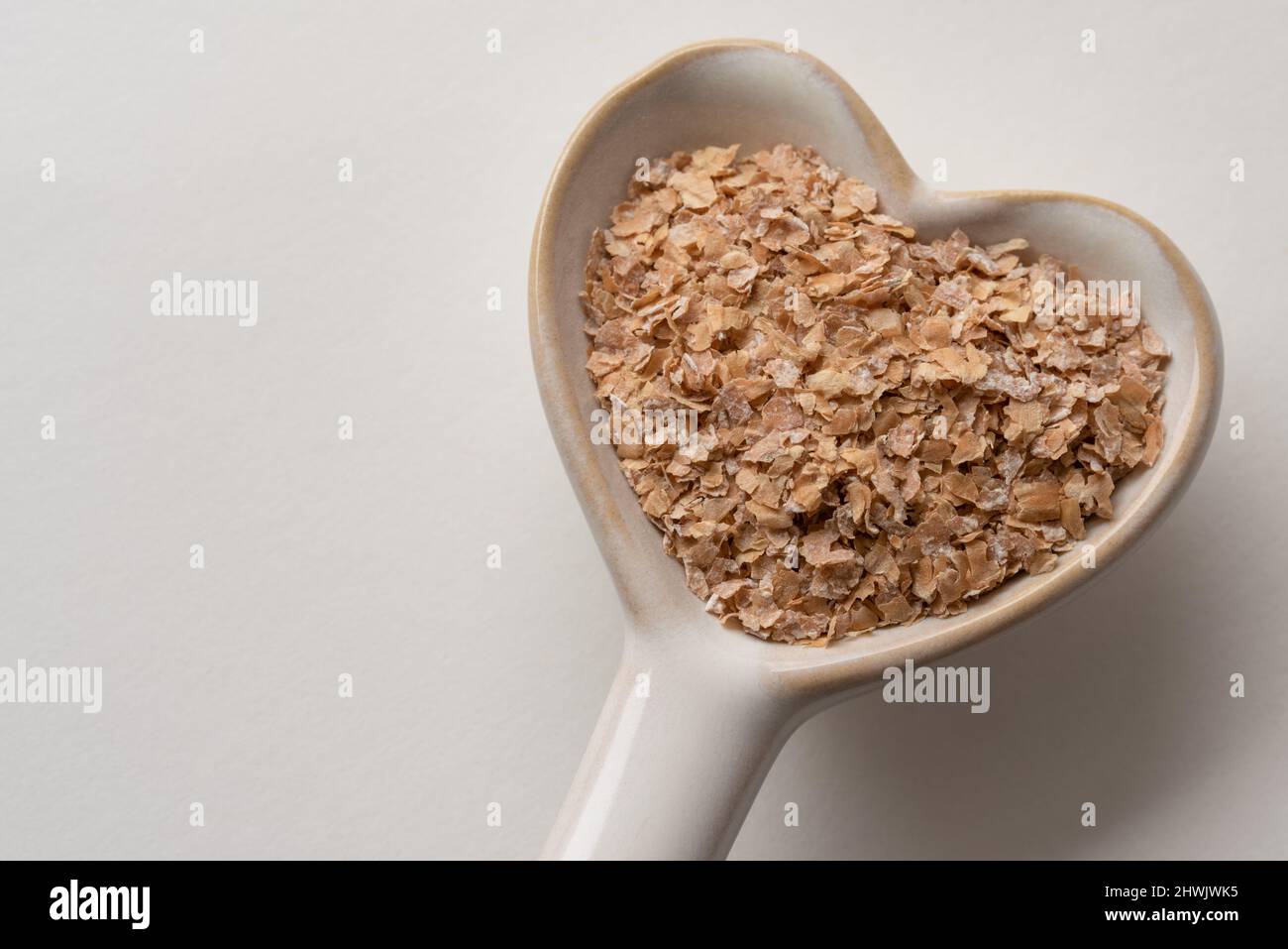Wheat Bran on a Heart Shaped Spoon Stock Photo
