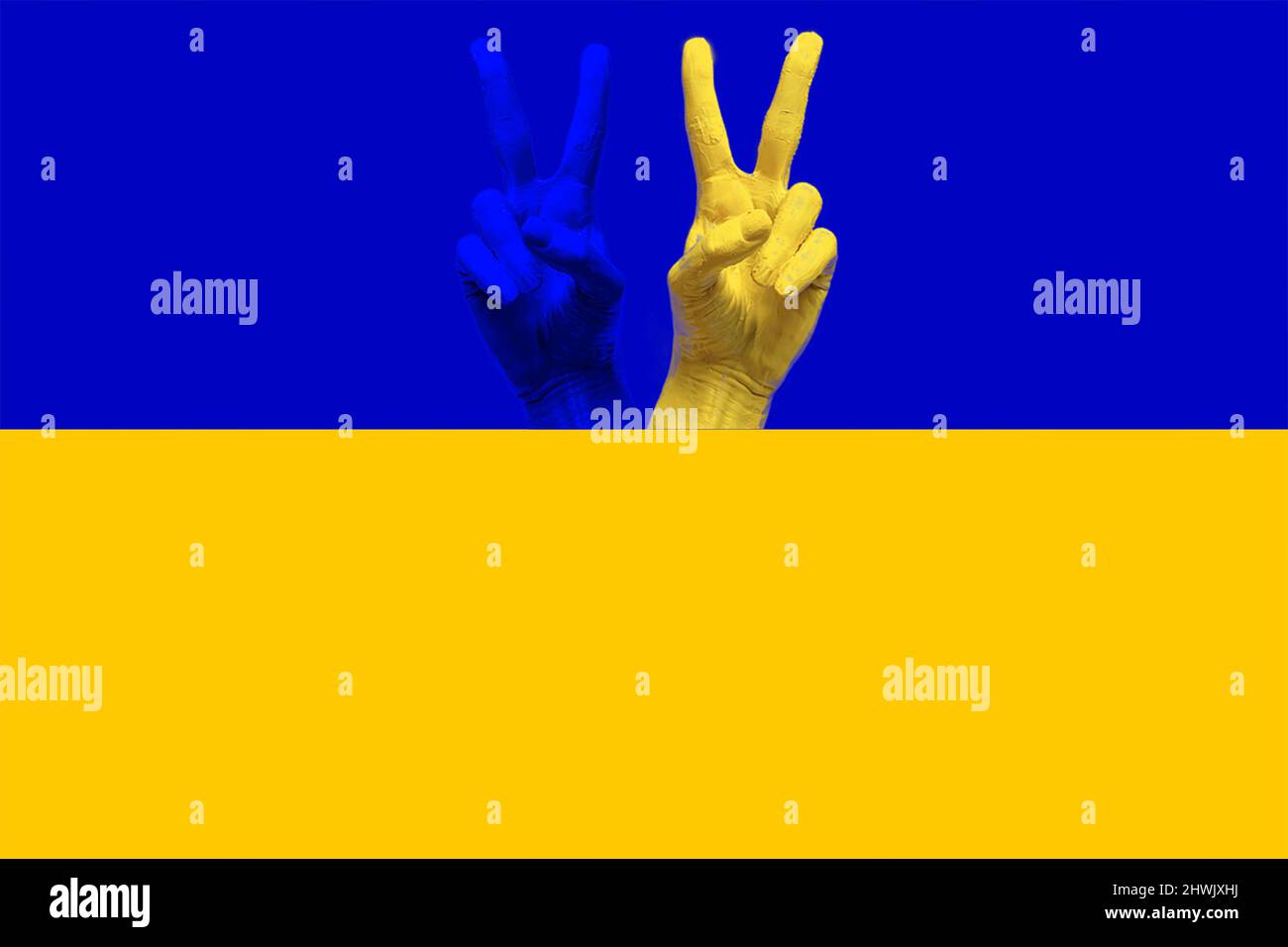 Ukraine hands on Ukrainian flag ok sign victory Stock Photo