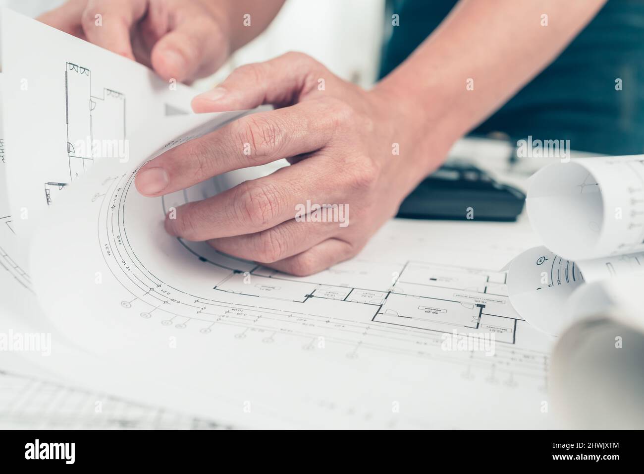 Architect engineer read drawing design working on bueprint. House