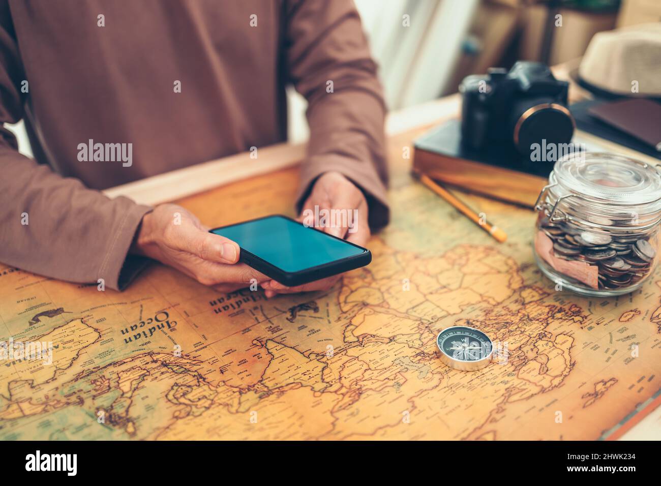 Tourist planning vacation, holidays or long weeked  and searching information or booking a hotel on a smart phone. Travel , Adventure and Discovery co Stock Photo
