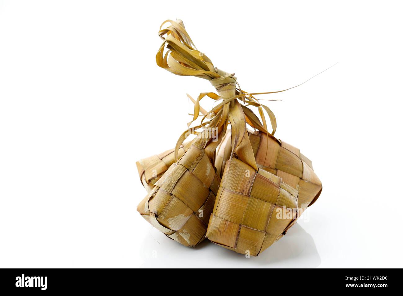 Popular Indonesia and  Malay traditional Ramadan Lebaran Food, Ketupat Rice or Ketupat Palas. Favorite Food for Breaking Fast, Eaten with Beef or Chic Stock Photo