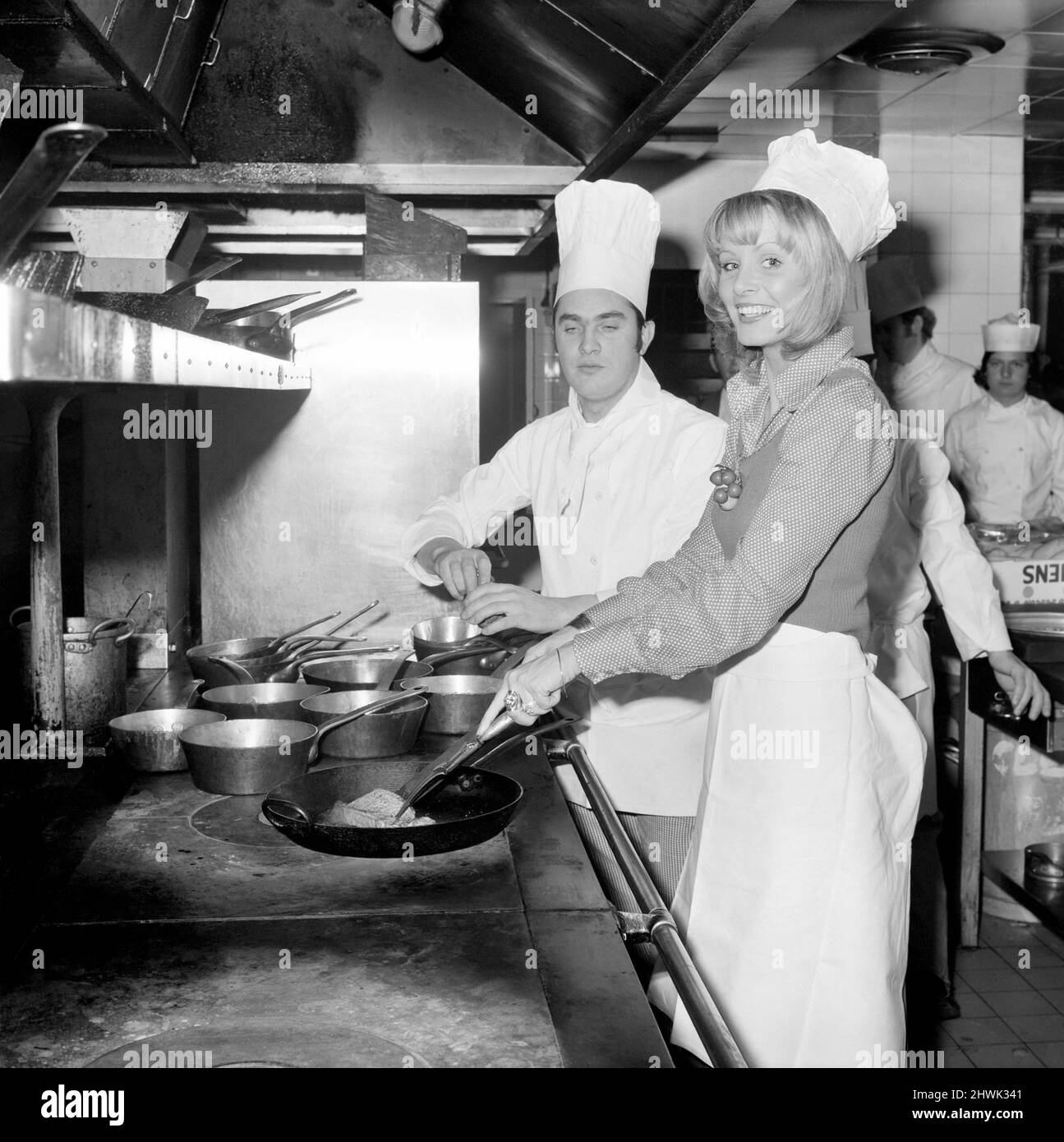 Miss World, 1972: Belinda Green: 20 year old Belinda Green, a blonde haired, blue eyed, model from Australia, won the Miss World Contest. Belinda's favourite hobby is cooking. Belinda in the kitchens of the Britannia Hotel, where she is staying, making herself something to eat this morning. December 1972 72-11299-001 Stock Photo